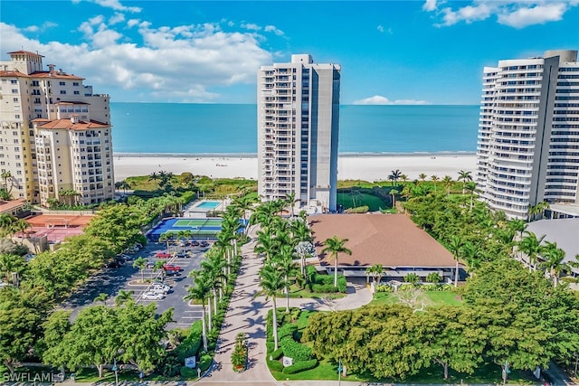 drone / aerial view featuring a water view and a view of the beach