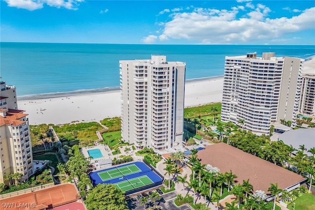 bird's eye view featuring a water view and a beach view