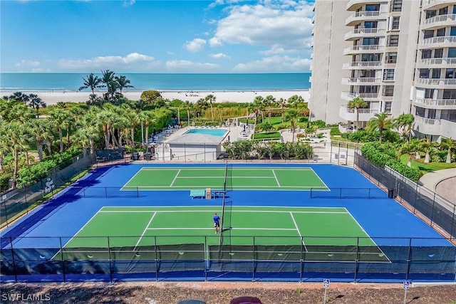 view of sport court with a water view