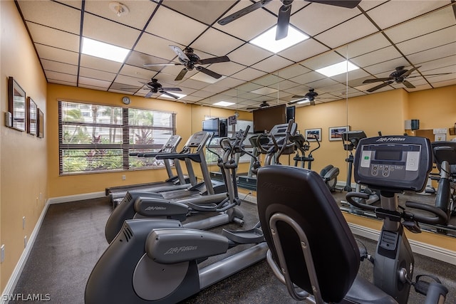 workout area with ceiling fan and a drop ceiling