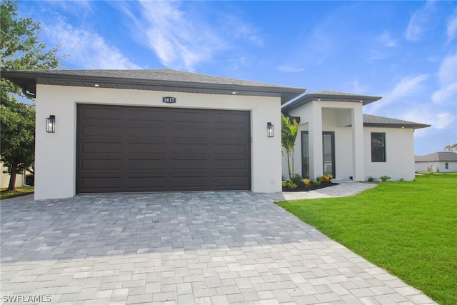 view of front of property with a front yard and a garage