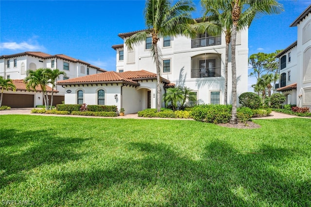 mediterranean / spanish-style house featuring a front yard