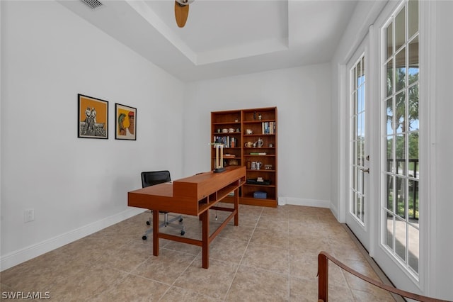 office area with french doors, ceiling fan, light tile patterned floors, and a raised ceiling