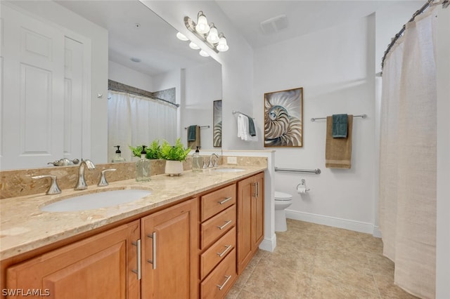 bathroom featuring toilet and vanity