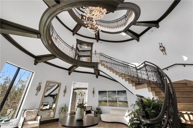 stairway featuring a high ceiling and a notable chandelier