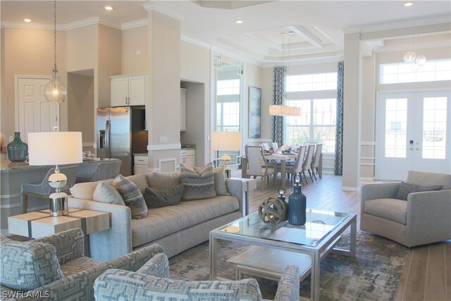 living room with french doors, dark wood-type flooring, a high ceiling, and ornamental molding