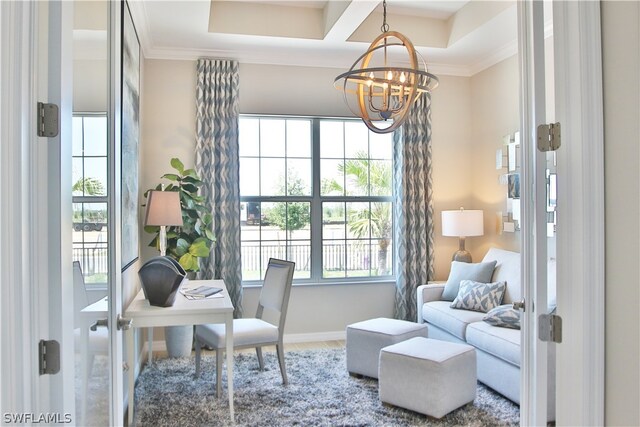 office featuring an inviting chandelier, a tray ceiling, and ornamental molding