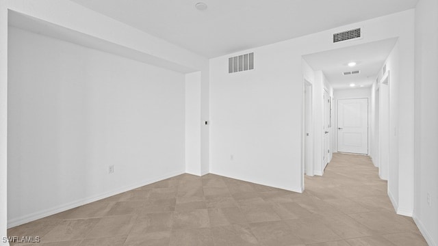 spare room featuring light tile patterned floors