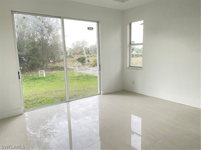 unfurnished room featuring light tile patterned flooring