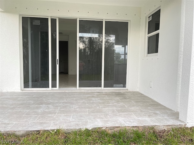 property entrance featuring a patio area