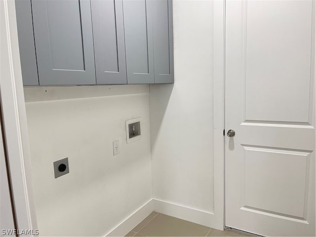 washroom featuring washer hookup, cabinets, light tile patterned flooring, and electric dryer hookup