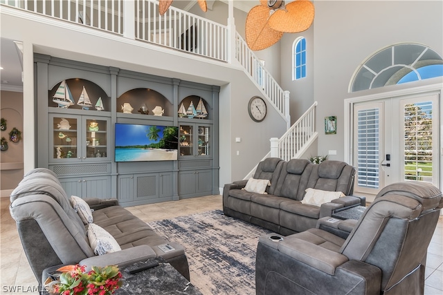 tiled living room with french doors and a high ceiling