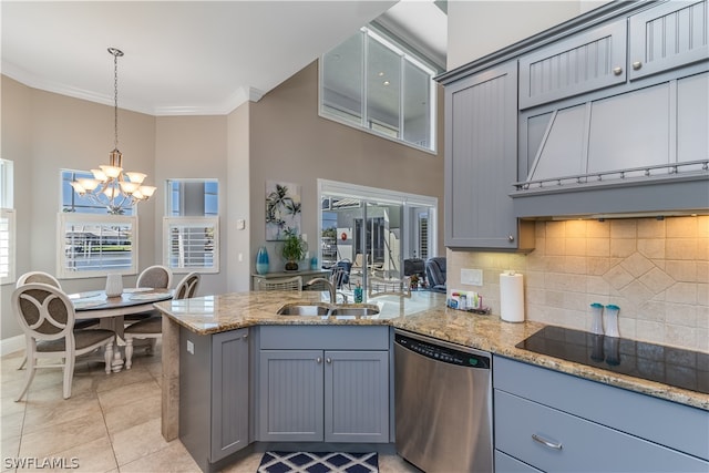 kitchen featuring stainless steel dishwasher, a notable chandelier, decorative light fixtures, light stone countertops, and sink