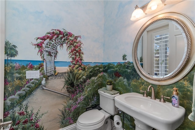 bathroom featuring toilet, sink, and a water view