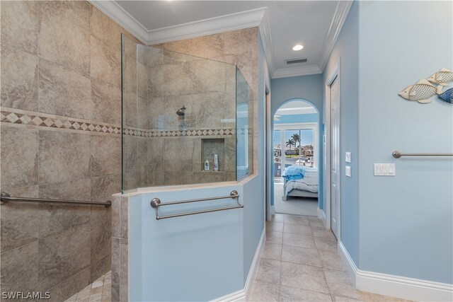 bathroom featuring crown molding, tile floors, and tiled shower