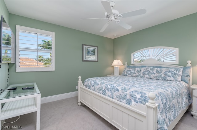 bedroom with ceiling fan and light colored carpet