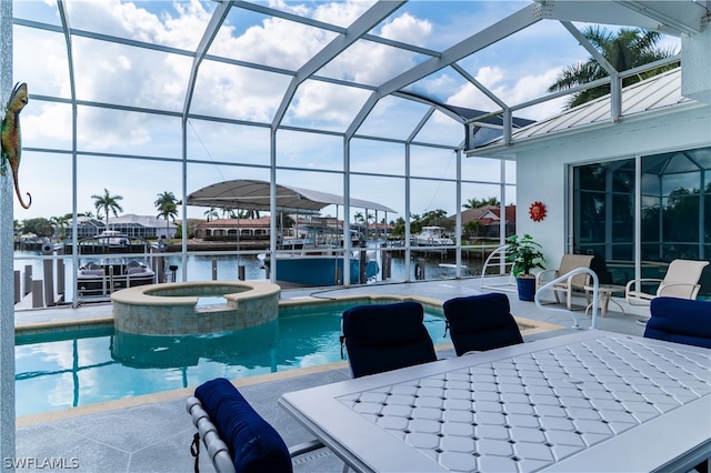 view of swimming pool featuring a patio area, an in ground hot tub, a water view, and a lanai