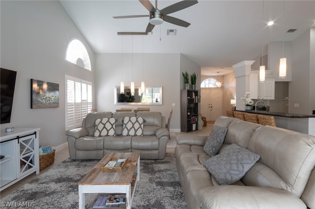 living room with high vaulted ceiling, sink, and ceiling fan