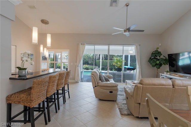 living room with light tile patterned floors, lofted ceiling, and ceiling fan