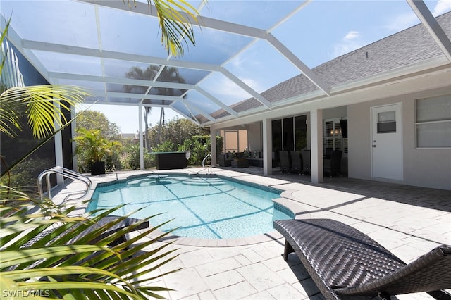 view of pool featuring a patio area and glass enclosure