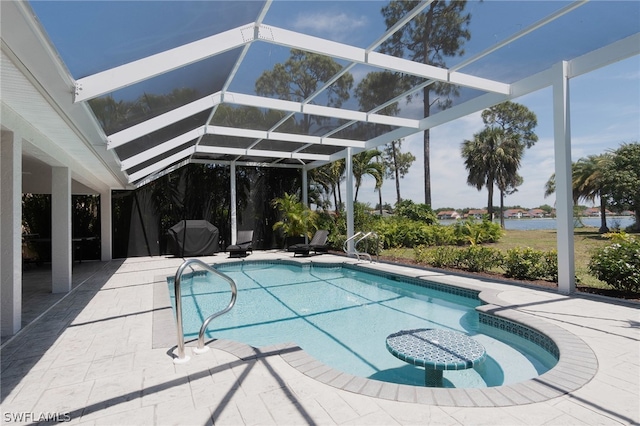 view of swimming pool featuring a patio and glass enclosure