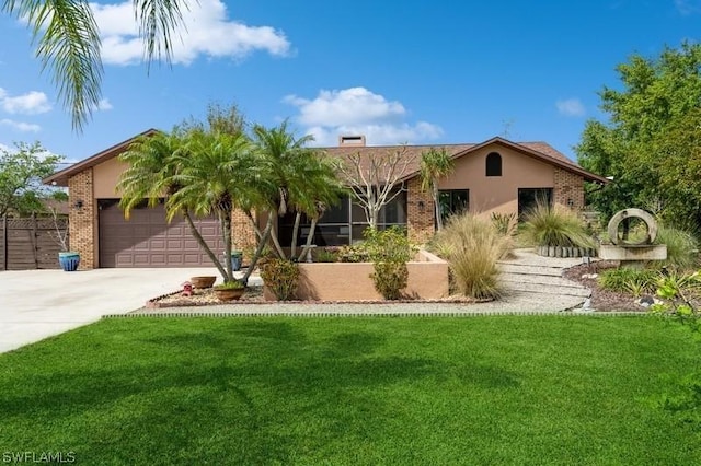 view of front of house featuring a garage and a front lawn