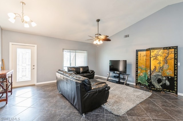 living room featuring plenty of natural light, ceiling fan with notable chandelier, and vaulted ceiling