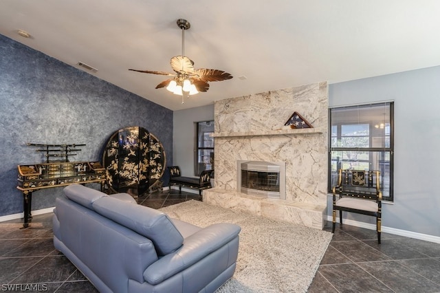 living room featuring a fireplace and ceiling fan