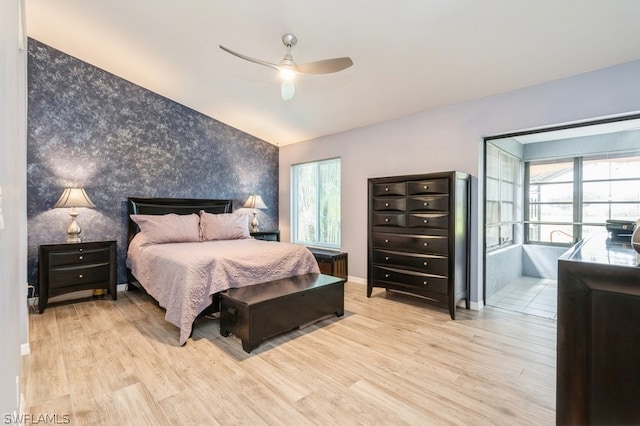 bedroom featuring multiple windows, ceiling fan, and light hardwood / wood-style flooring