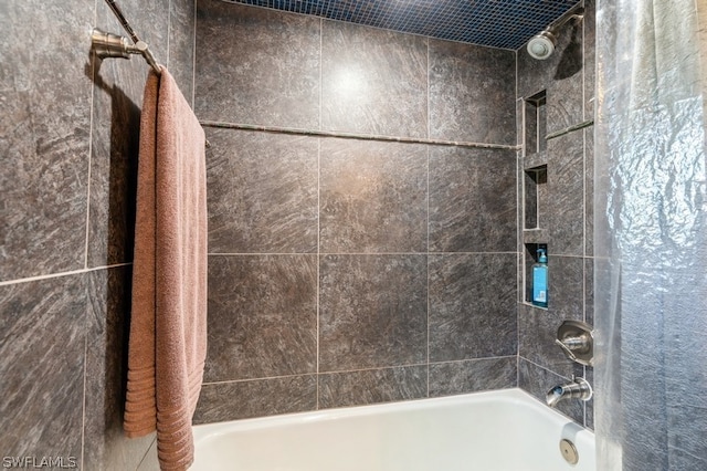 bathroom with shower / bath combo with shower curtain