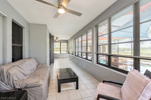 sunroom featuring ceiling fan