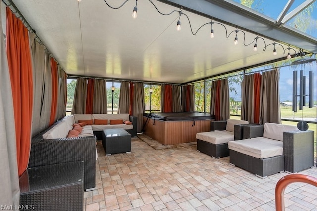 view of patio / terrace featuring an outdoor living space and a hot tub