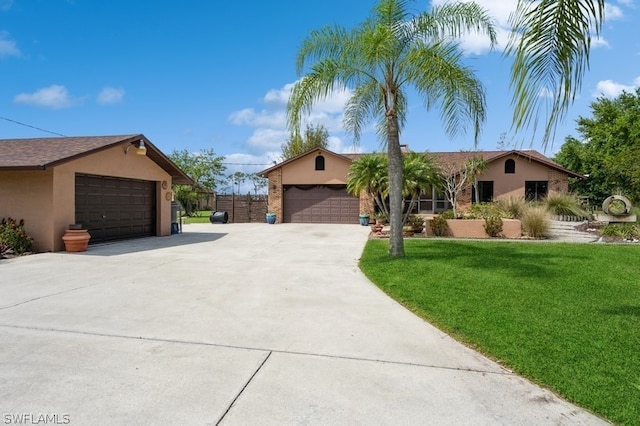 single story home featuring a front lawn and a garage