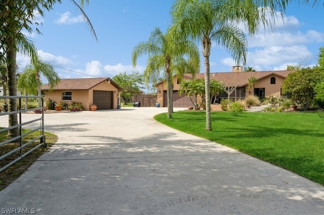 ranch-style house featuring a front yard and a garage