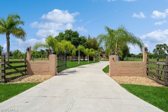 view of gate featuring a yard