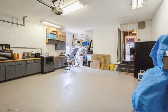 garage featuring a garage door opener and washer / clothes dryer