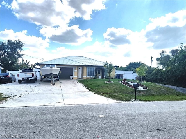 single story home with a front yard and a garage