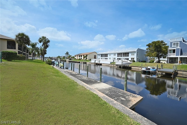 dock area featuring a yard and a water view