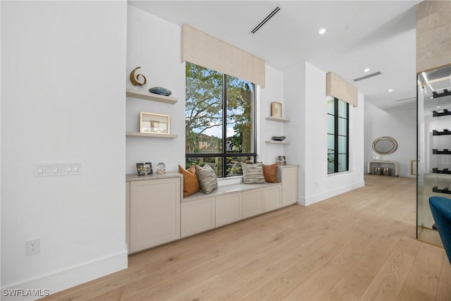 sitting room featuring recessed lighting, light wood-type flooring, visible vents, and baseboards