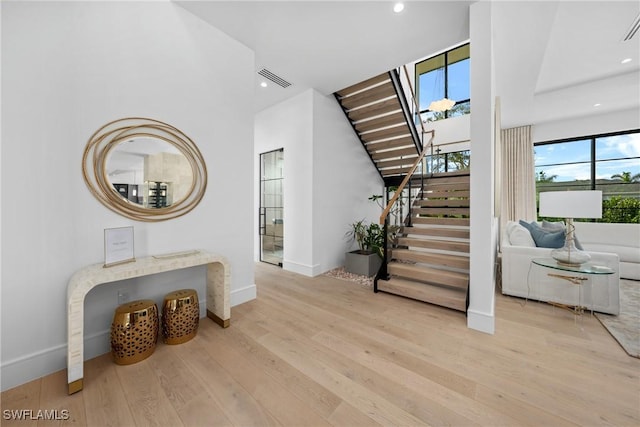 interior space with baseboards, wood finished floors, visible vents, and recessed lighting