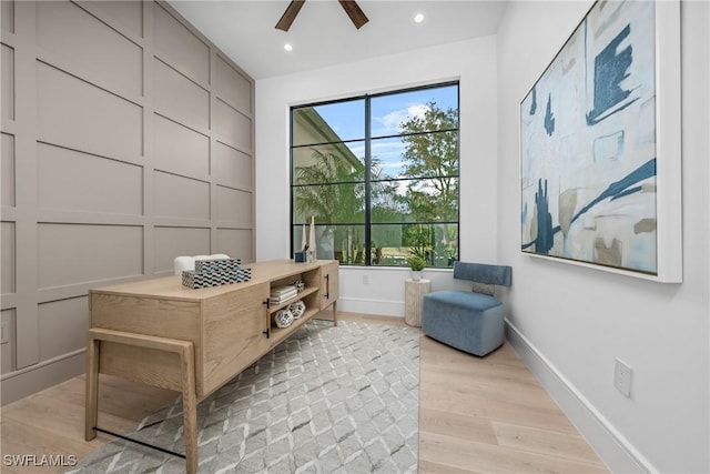 living area featuring a wealth of natural light, baseboards, light wood finished floors, and recessed lighting