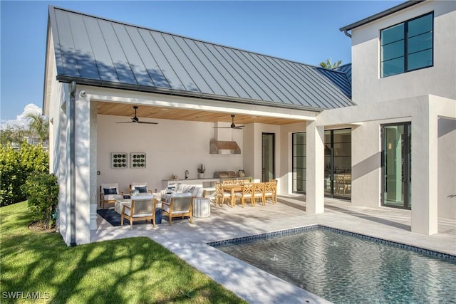 rear view of house featuring ceiling fan, metal roof, an outdoor living space, an outdoor pool, and a standing seam roof