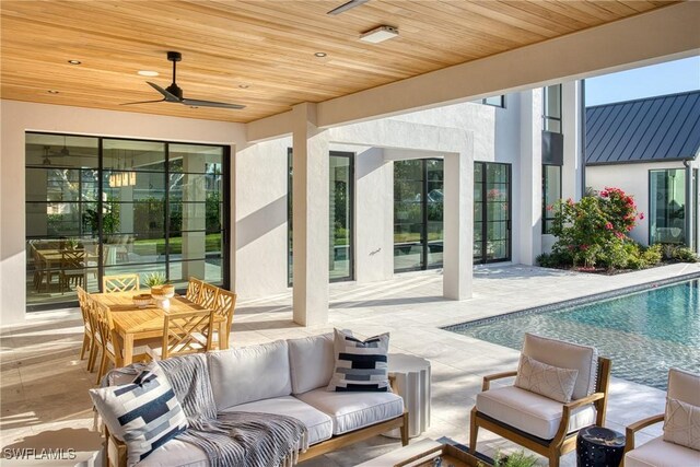 view of patio featuring a ceiling fan, an outdoor pool, and an outdoor living space