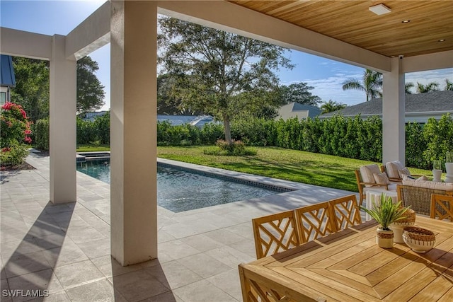 view of swimming pool with an outdoor living space, a lawn, a patio area, and a fenced in pool