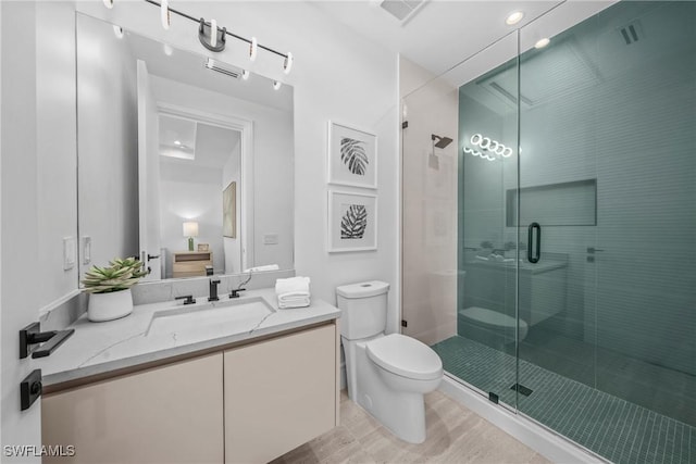 bathroom featuring toilet, a shower stall, visible vents, and vanity