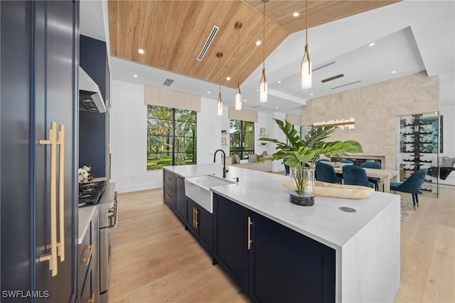 kitchen featuring pendant lighting, a spacious island, wood ceiling, a sink, and high end refrigerator