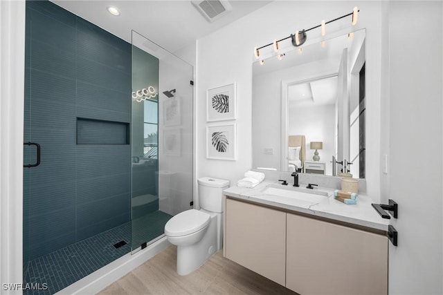 full bathroom featuring visible vents, toilet, connected bathroom, vanity, and wood finished floors