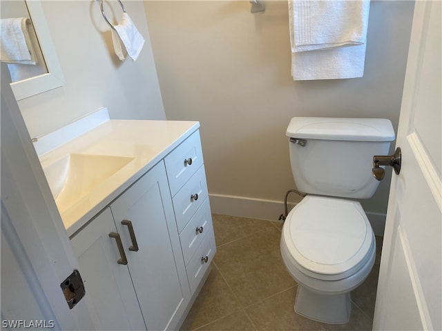 bathroom featuring vanity, tile flooring, and toilet