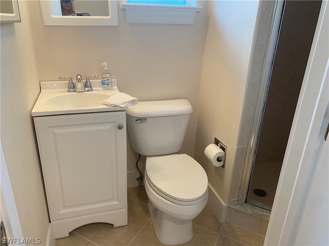 bathroom with walk in shower, toilet, tile floors, and vanity