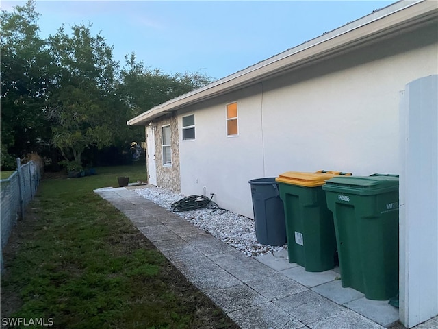 view of property exterior with a lawn